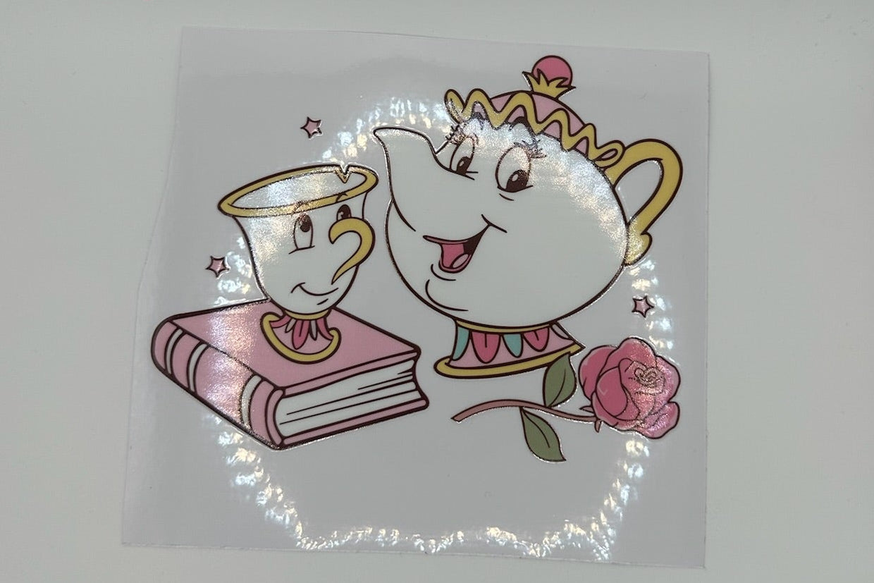 Cartoon teapot and cup with a rose on a white background