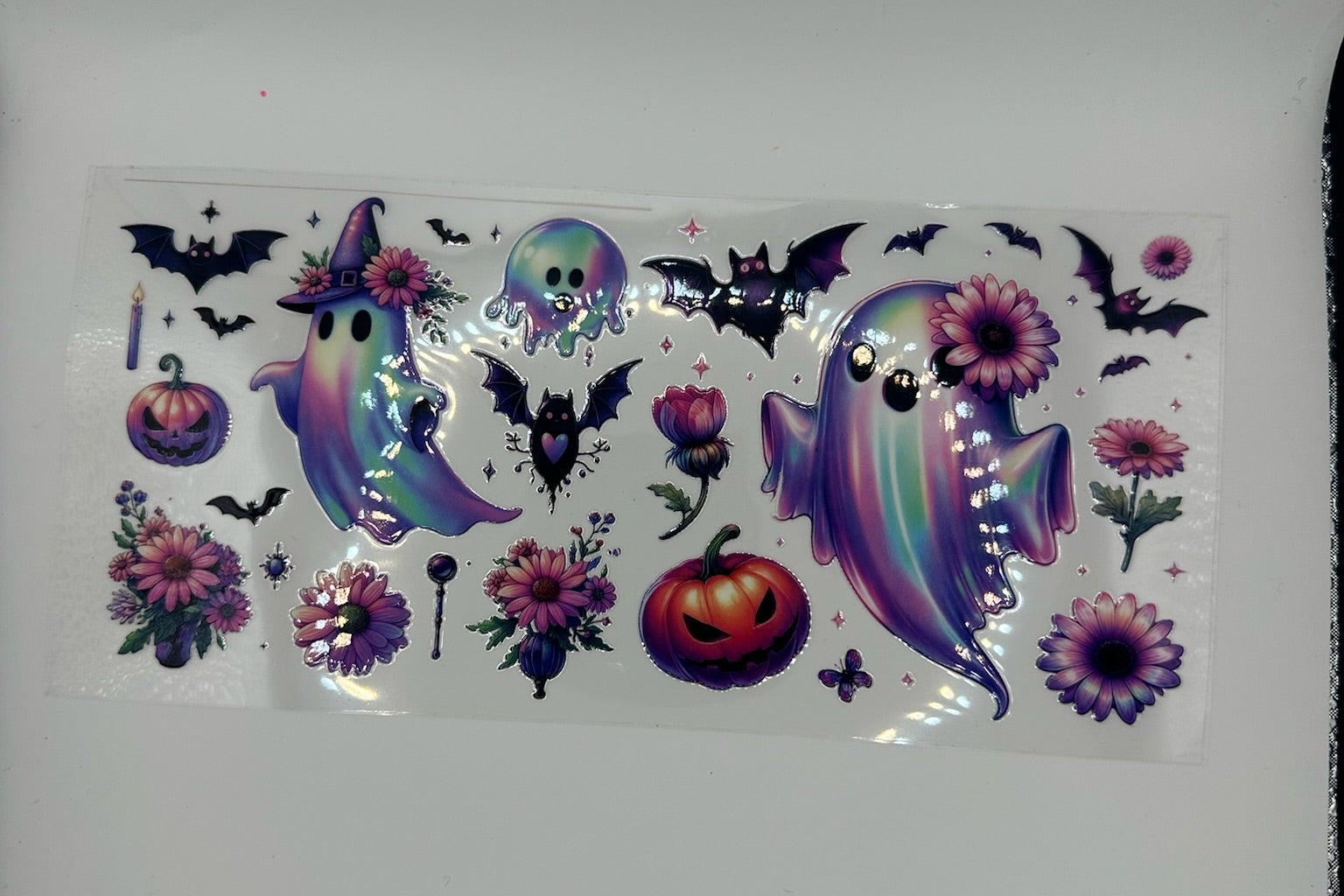 Halloween-themed sticker sheet with ghosts, pumpkins, and flowers on a white background