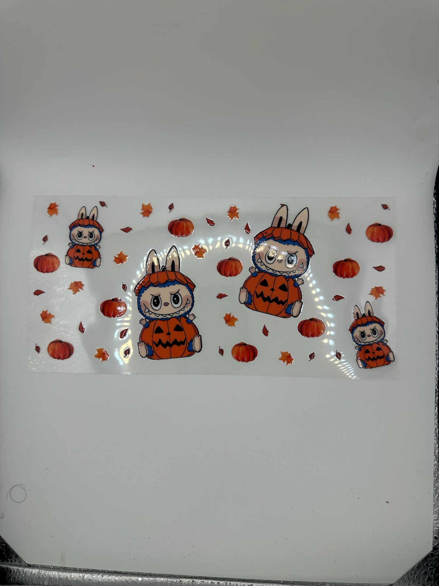 Sticker design of cartoon bunnies in Halloween costumes on a white background
