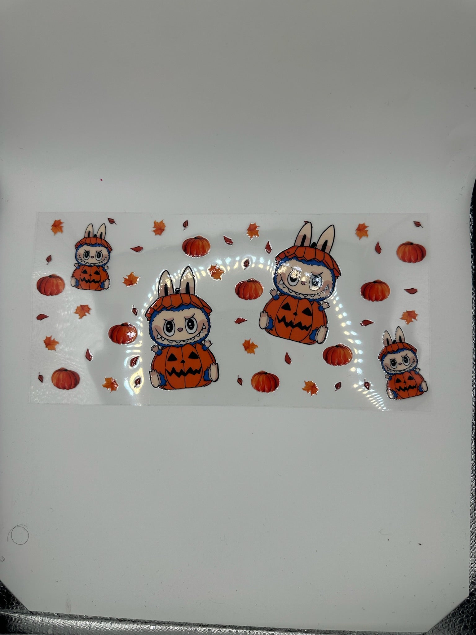 Sticker design of cartoon bunnies in Halloween costumes on a white background