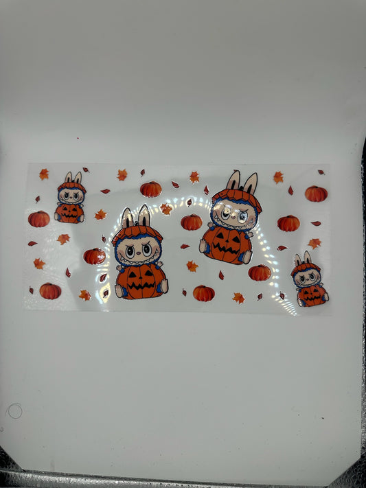 Sticker design of cartoon bunnies in Halloween costumes on a white background